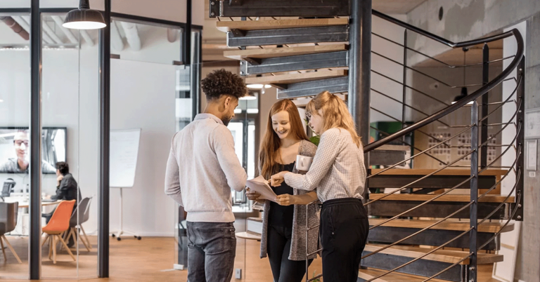 Kate Edwards HR expertise for small businesses, image shows three work colleagues in modern workspace in conversation