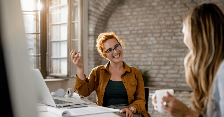 Kate Edwards HR Solutions, shows two ladies having a friendly conversation in the office.